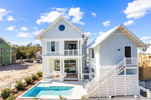 back of house featuring a patio area and a balcony