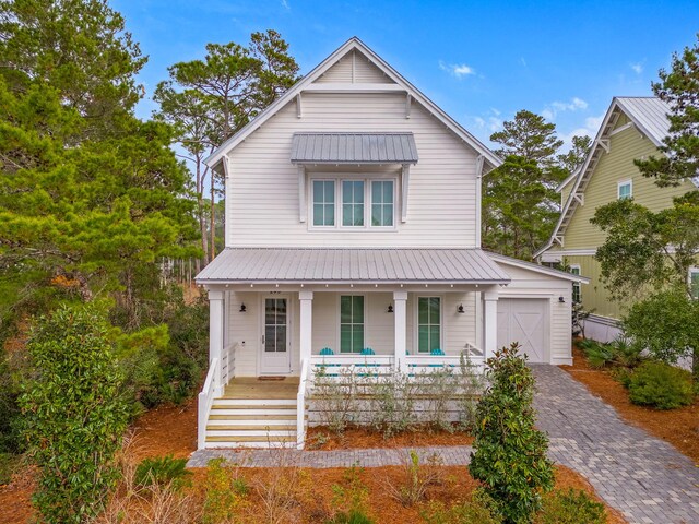 view of front of house with a porch and a garage