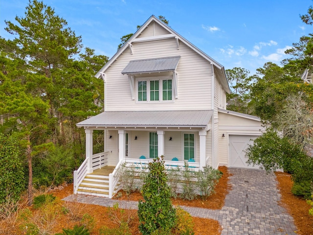 view of front of home featuring covered porch and a garage