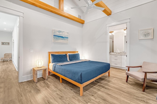 bedroom with ensuite bathroom, wood ceiling, ceiling fan, beam ceiling, and light hardwood / wood-style flooring