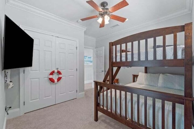 bedroom with ceiling fan, light carpet, and ornamental molding