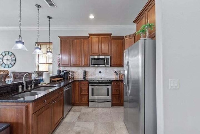 1900 Baytowne Loop, Miramar Beach, FL 32550 - kitchen featuring appliances with stainless steel finishes, a sink, crown molding, dark stone counters, and brown cabinets