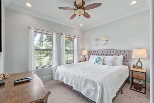 bedroom featuring ceiling fan, light colored carpet, and crown molding