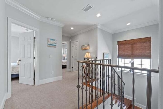 corridor featuring light colored carpet and ornamental molding