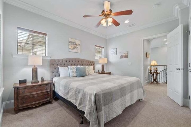 carpeted bedroom with ceiling fan and crown molding