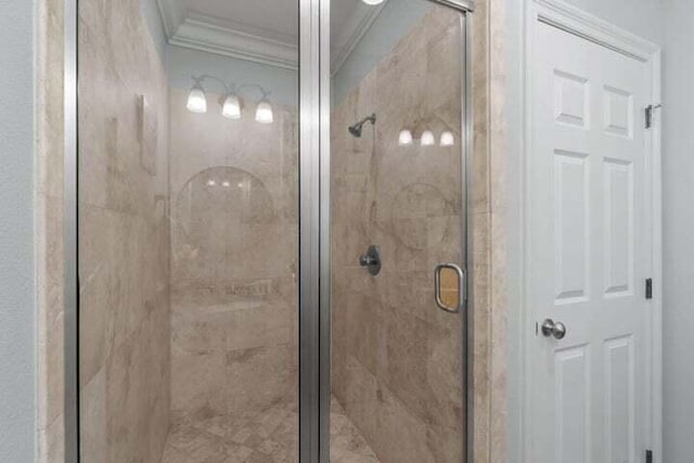 bathroom with an enclosed shower and ornamental molding