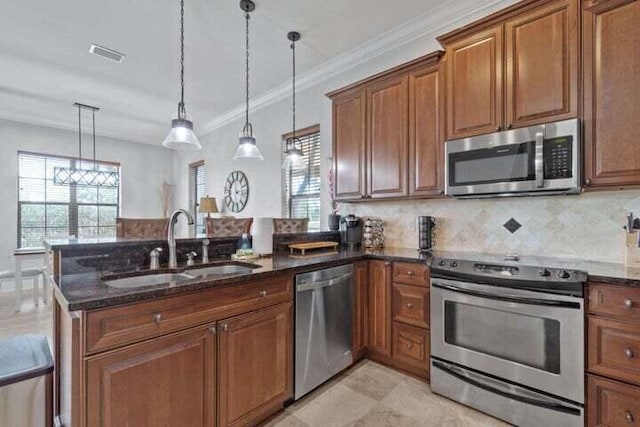 1900 Baytowne Loop, Miramar Beach, FL 32550 - kitchen featuring appliances with stainless steel finishes, a sink, brown cabinets, and ornamental molding