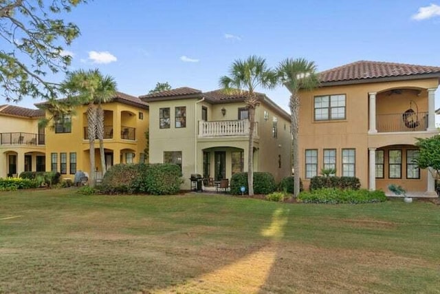1900 Baytowne Loop, Miramar Beach, FL 32550 - view of front facade featuring a balcony, stucco siding, a front yard, and a tile roof