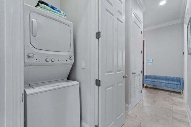 1900 Baytowne Loop, Miramar Beach, FL 32550 - laundry area featuring stacked washer / dryer, ornamental molding, and baseboards