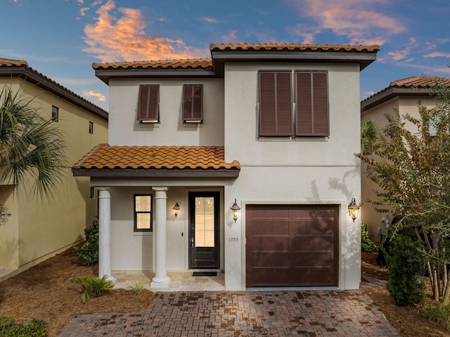 mediterranean / spanish house with a garage