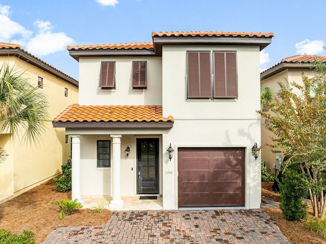 mediterranean / spanish-style house with a garage