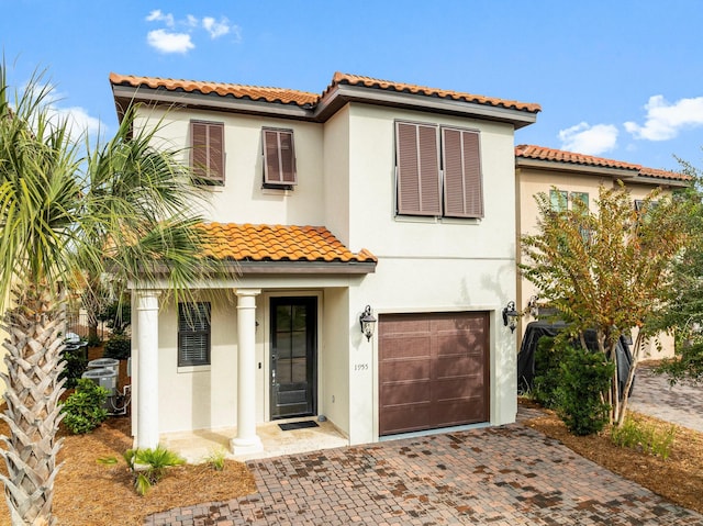 mediterranean / spanish house with a garage