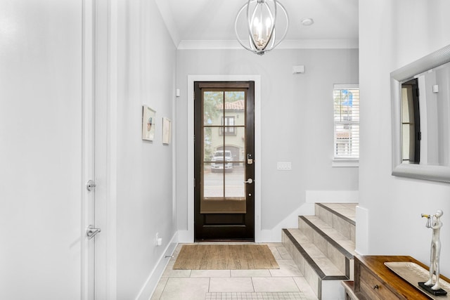 foyer with light tile patterned flooring, ornamental molding, and an inviting chandelier