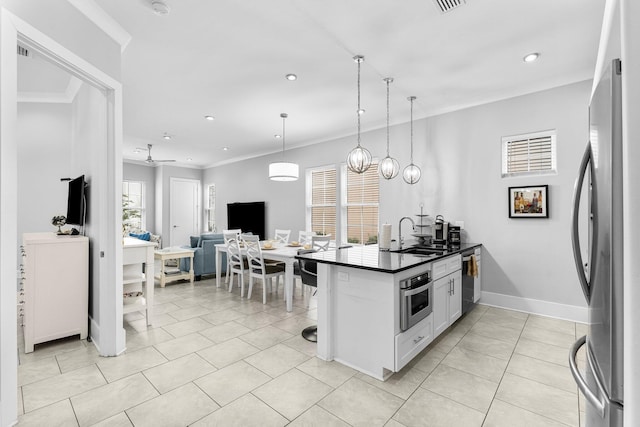 kitchen featuring white cabinets, a healthy amount of sunlight, sink, and stainless steel appliances