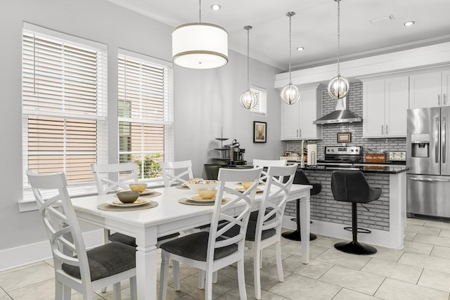 tiled dining space with ornamental molding