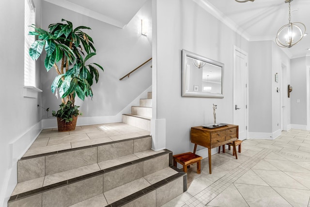 stairway with ornamental molding and a chandelier