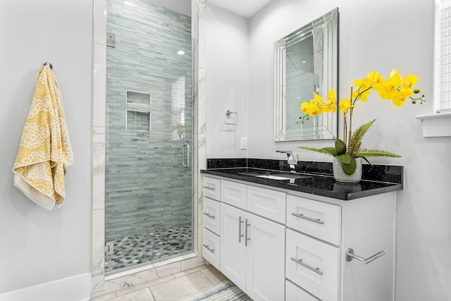 bathroom featuring vanity and a shower with shower door