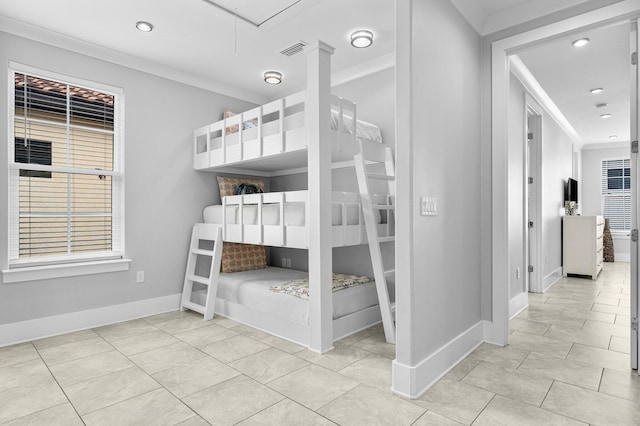 unfurnished bedroom featuring light tile patterned floors and crown molding