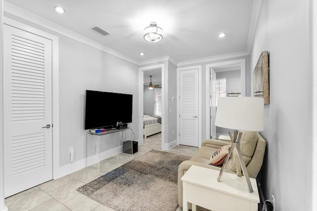 living room with light tile patterned flooring and ornamental molding