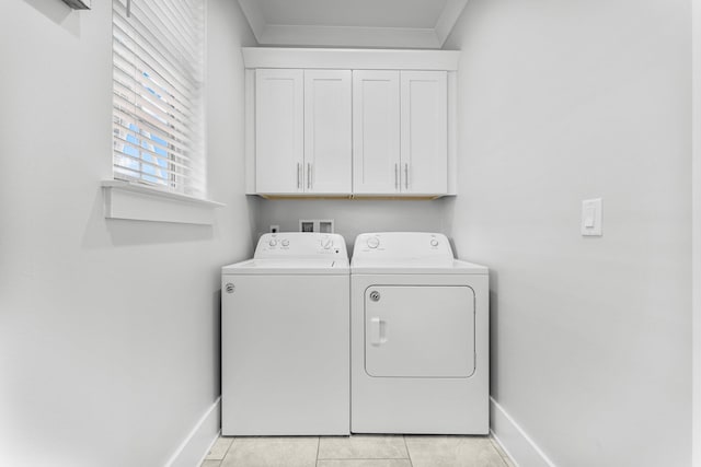 laundry area featuring cabinets, light tile patterned floors, and separate washer and dryer