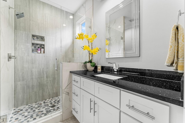 bathroom with vanity and a shower with shower door