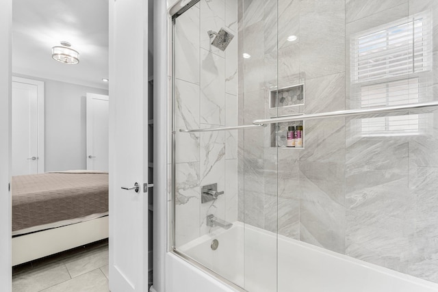 bathroom featuring shower / bath combination with glass door and tile patterned flooring