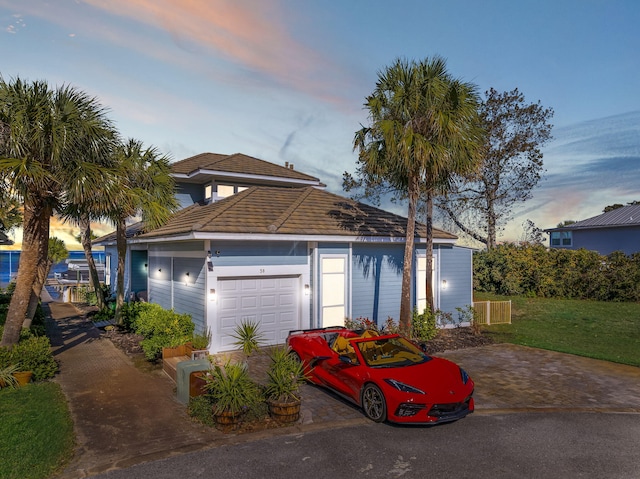 view of front of home with a lawn and a garage