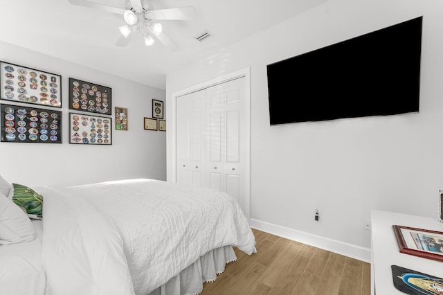 bedroom with ceiling fan, a closet, and light hardwood / wood-style flooring