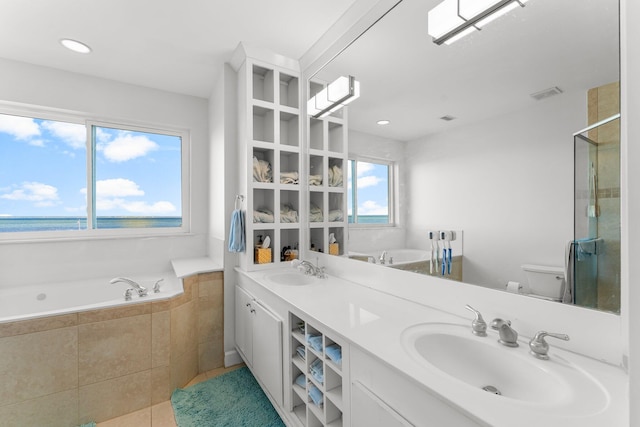 full bathroom with tile patterned flooring, a water view, toilet, and a wealth of natural light