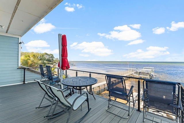 wooden deck with a water view and a view of the beach