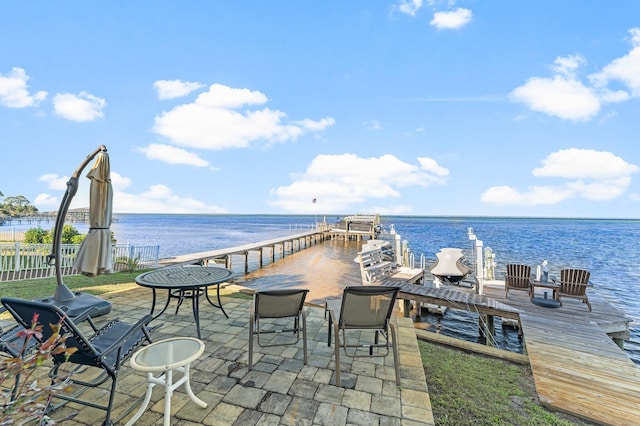 view of patio / terrace with a dock and a water view