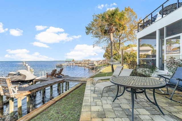 view of patio / terrace featuring a sunroom, a water view, a balcony, and a dock