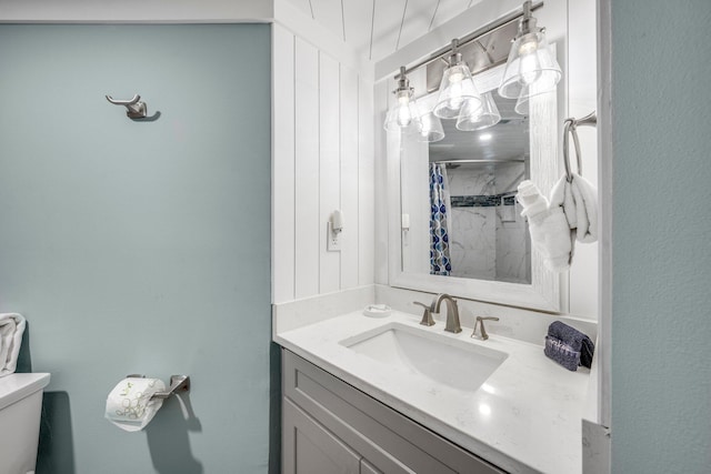 bathroom featuring vanity, curtained shower, and toilet