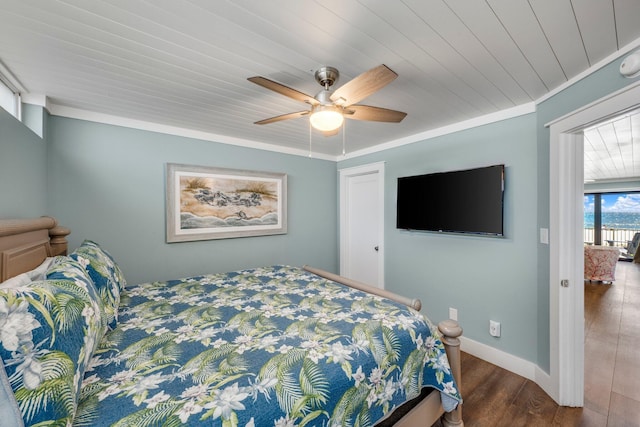 bedroom with dark hardwood / wood-style floors, ceiling fan, and crown molding