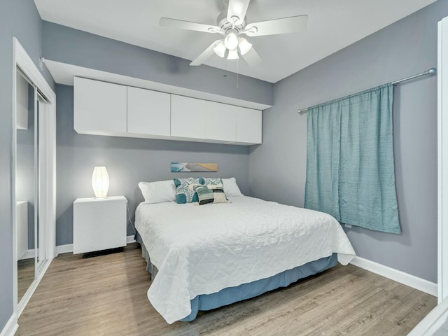 bedroom featuring ceiling fan, light hardwood / wood-style floors, and a closet