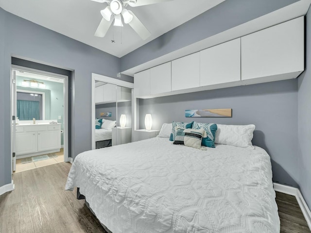 bedroom with ceiling fan, dark hardwood / wood-style flooring, sink, and a closet