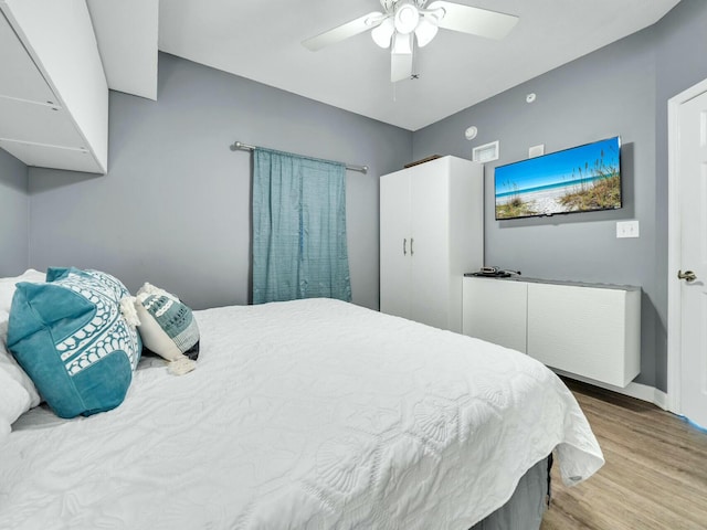 bedroom featuring ceiling fan and light hardwood / wood-style flooring