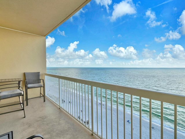 balcony with a water view and a beach view