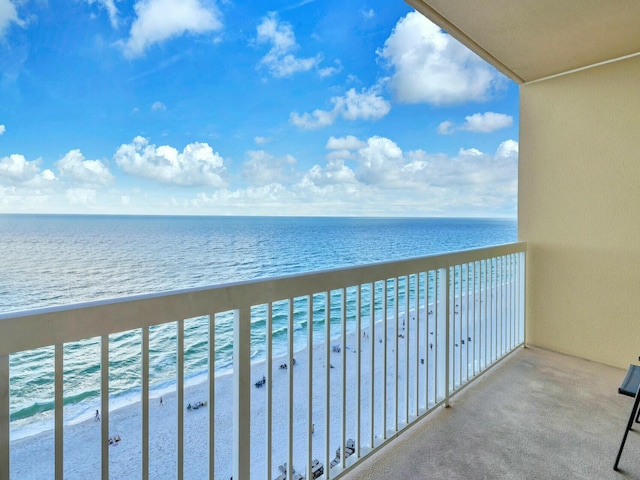 balcony with a water view and a beach view