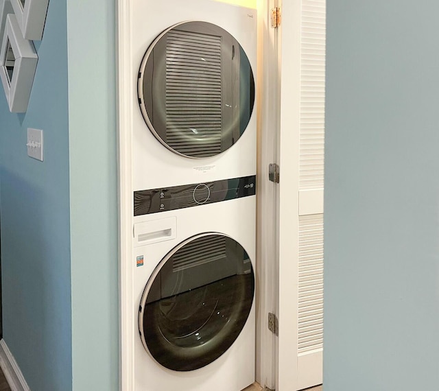 washroom featuring stacked washer and dryer