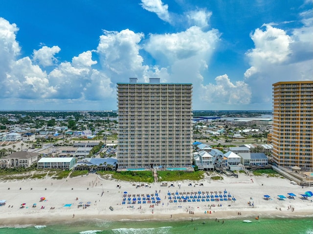 birds eye view of property with a water view and a beach view