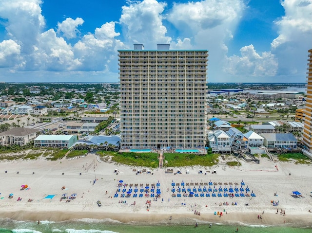 birds eye view of property featuring a beach view and a water view