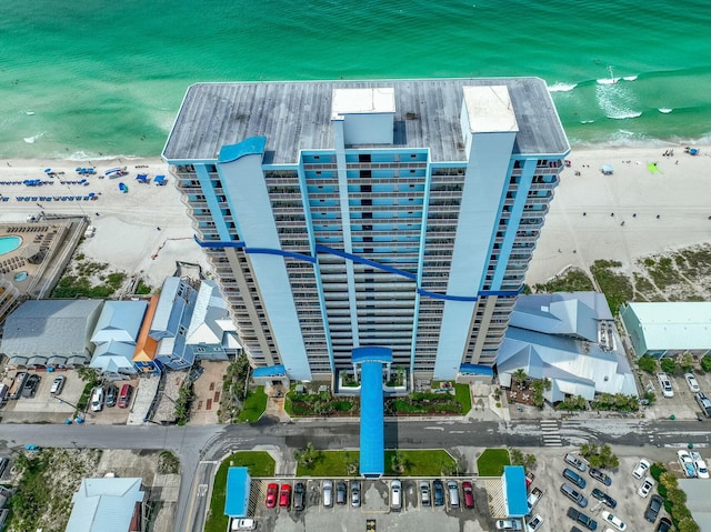 birds eye view of property with a beach view and a water view