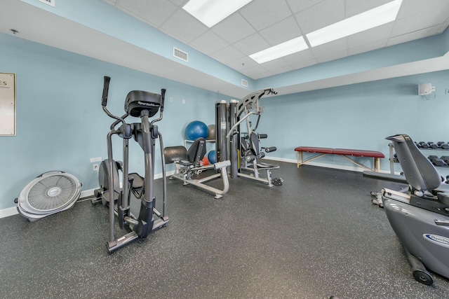 gym with a paneled ceiling