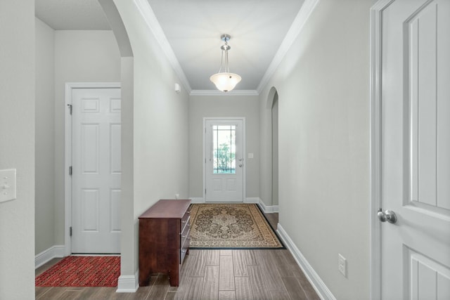 doorway to outside featuring dark hardwood / wood-style floors and ornamental molding