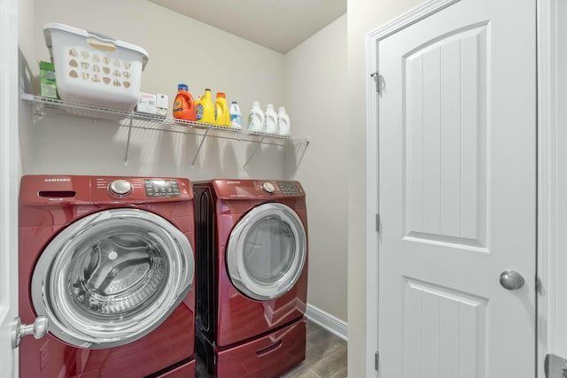 laundry area with independent washer and dryer and hardwood / wood-style flooring