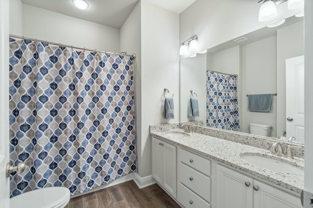 bathroom featuring vanity and toilet