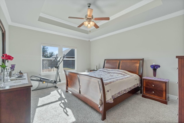 bedroom with light carpet, a tray ceiling, ceiling fan, and ornamental molding