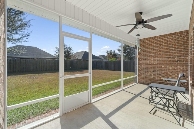 unfurnished sunroom with ceiling fan and a healthy amount of sunlight