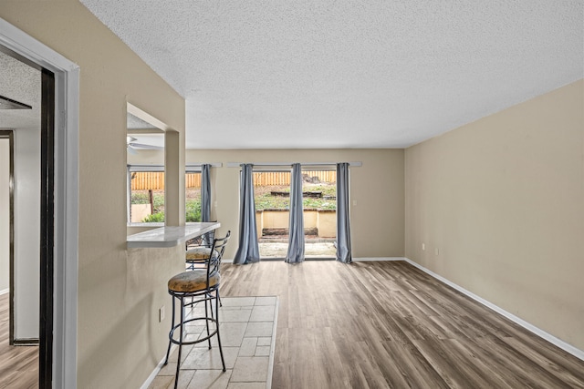 spare room featuring a textured ceiling and light wood-type flooring